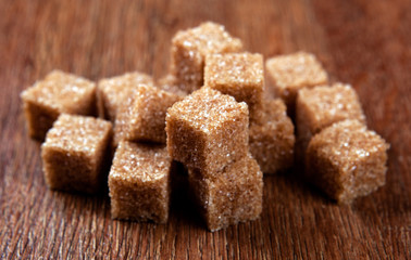 cubes of brown sugar on a wooden surface