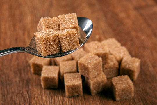 tablespoon with cubes of brown sugar