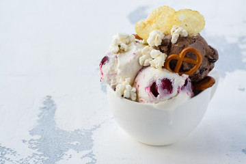 Chocolate and vanilla ice cream with berries, bretzel, salty popcorn and potato chips. Space for text