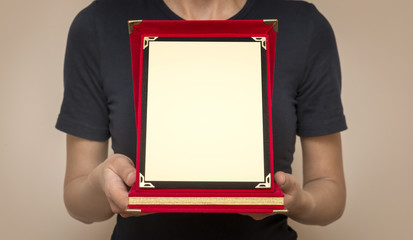 Woman Holding A Commemorative Plaque In Her Hands 