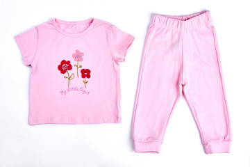 Baby-girl pink t-shirt and trousers. Newborn baby girl adorable pink cotton suit on white background. Toddler girl beautiful apparel on sale.