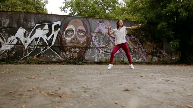 fitness, sport, dance and lifestyle concept - group of smiling people with coach dancing zumba in gym or studio