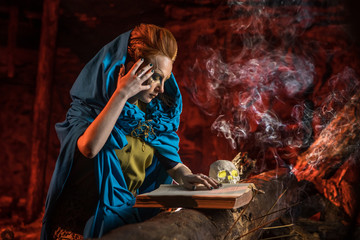 Beautiful red haired witch with the spellbook.
