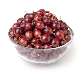 Red gooseberries in glass bowl isolated on white background