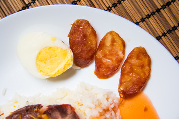 Barbecued red pork and crispy pork in sauce with rice