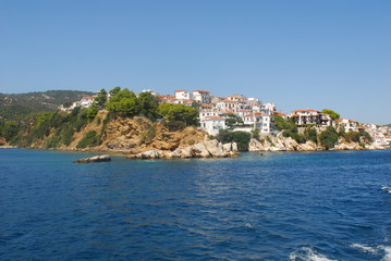 Fototapeta premium Skiathos town on Skiathos Island, Greece. Beautiful view of the old town with boats in the harbor.