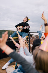 Musician live performance at birthday party. Friends company at leisure time, confident guitarist...