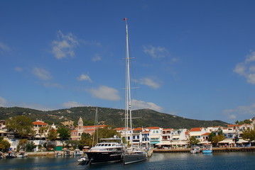 Fototapeta na wymiar Skiathos town on Skiathos Island, Greece. Beautiful view of the old town with boats in the harbor.