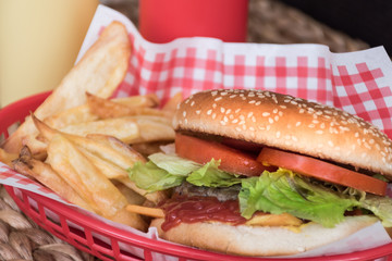 Close-up of hamburger with chips in a basket.