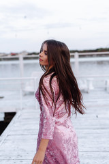 Obraz premium fashion portrait of happy beautiful Hispanic latino girl in purple dress with long hair