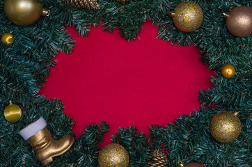 Ótimo fundo de natal vermelho com folhas verdes de pinheiro e objetos decorativos de celebração natalina