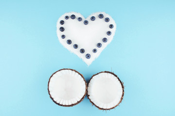 Coconut on blue background with berries.