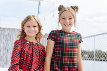 Two stylish happy beautiful fashionable girls wear in red