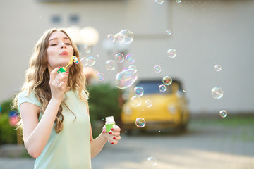 happy woman blowing soap bubbles 