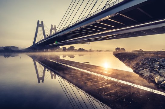 Fototapeta Cable stayed bridge, Krakow, Poland, in the morning fog over Vistula river