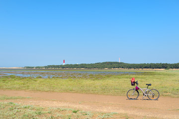 Bike and lighthouse at the French Atlantic coast