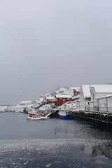 Fishing boats-wooden white port warehouses-red rorbuer cottages. Hamnoy-Reine-Moskenes-Lofoten-Nordland fylke-Norway. 0395