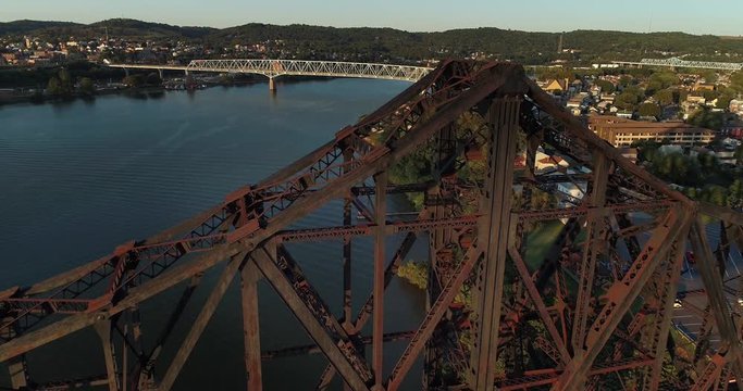 A high angle aerial establishing shot of the various bridges spanning the Ohio River in Western Pennsylvania. The towns of Monaca and Rochester, PA in the distance.  	
