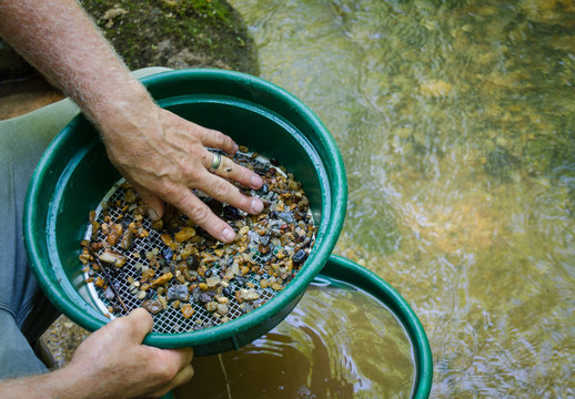 Gold panning and gem mining. Classify soil, pebbles and dirt to prepare to pan for gold and gemstones. Fun and adventure, recreational activity.