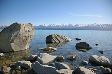 Boulders in Lake Pukaki, with the Southern Alps behind, Canterbury, New Zealand