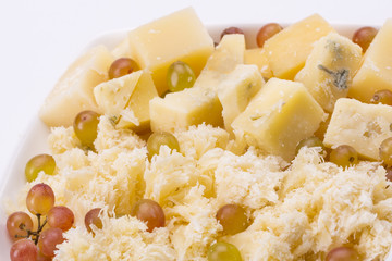 Set of cheeses and grapes on a white background