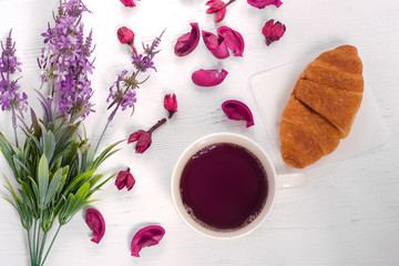 Flowers cup of tea croissant