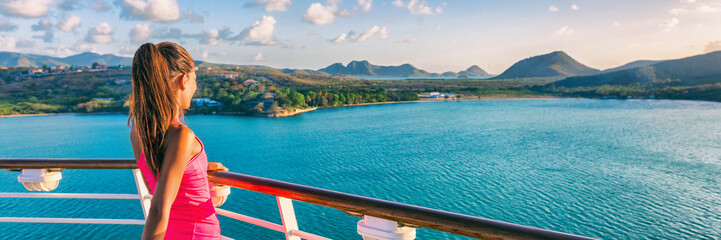 Cruise ship tourist woman Caribbean travel vacation banner. Panoramic crop of girl enjoying sunset view from boat deck leaving port of Basseterre, St. Lucia, tropical island. - obrazy, fototapety, plakaty