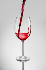 filling wine glass isolated on white background