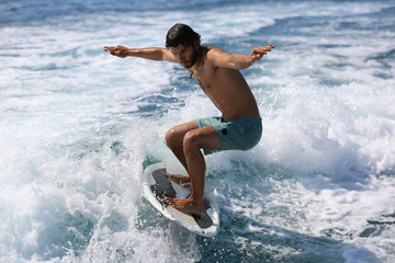 Fototapeta premium Young man surfing on the wave.