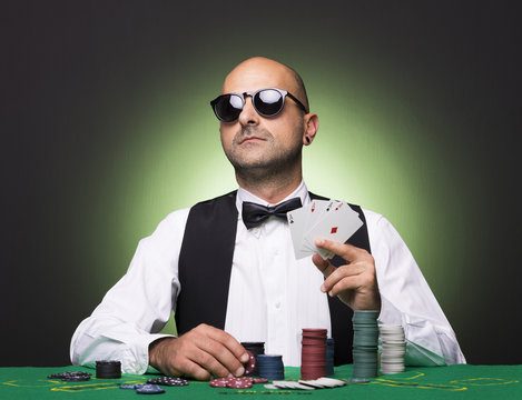 Poker player showing poker cards at the table