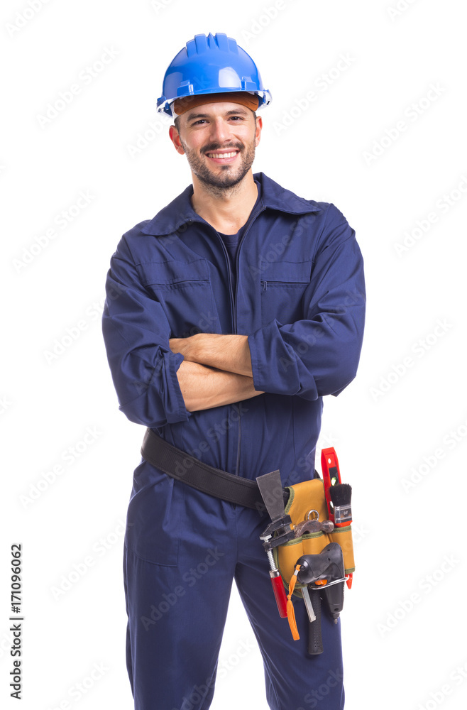 Wall mural portrait of a smiling young worker standing with arms crossed on white background