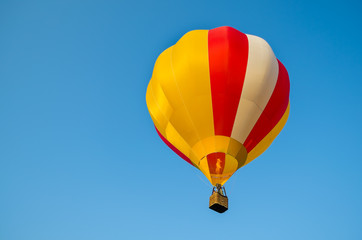 Colorful of Hot air balloon with fire and blue sky background