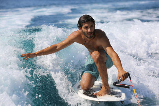 Young Man Surfing On The Wave.