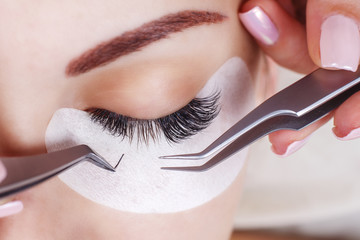 Eyelash Extension Procedure. Woman Eye with Long Eyelashes. Lashes, close up, macro, selective focus. - 171096435