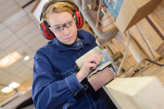 Female carpenter at work - Powered by Adobe