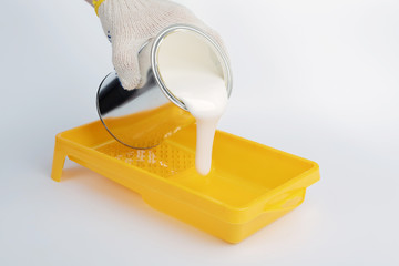 Pouring paint into a painting tray