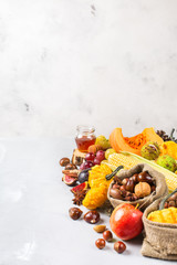 Fall autumn harvest background with pumpkin apple chestnut corn