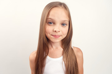Fototapeta premium little girl with long straight hair on a white background, portrait, close-up