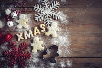 Xmas gingerbread cookies on wooden background with blank space