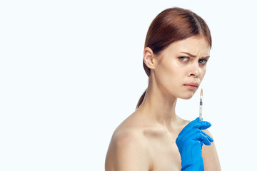 beautiful young woman holding a syringe, blank space for copy