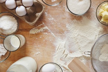Frame baking ingredients background. Flat lay white products prepare for cooking on wooden cutting board.