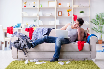 Young man working studying in messy room
