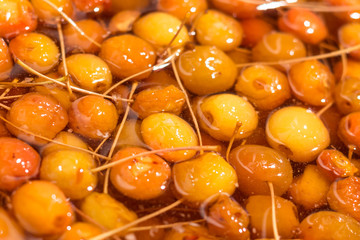 Yellow apples in sweet syrup or honey during the preparation of jam.