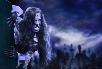 Undead zombie scary girl on halloween graveyard at night on dark clouds sky background. Dangers...