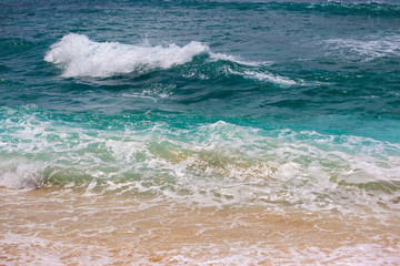 Indian ocean texture. Turquoise sea water with white foam and big wave. Powerful and peaceful nature concept.