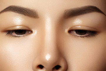Beautiful female eye with clean skin, daily fashion makeup. Asian model face. Perfect shape of...