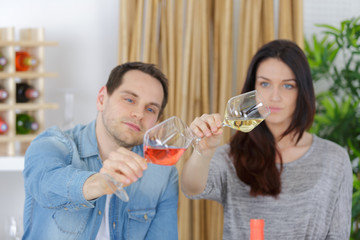 young winery employees checking up quality of wine in glass