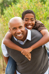 African American father and son talking and laughing.