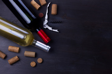 Bottles of red and white wine with corks on table