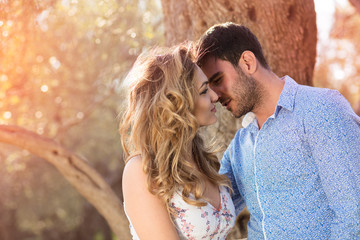 Beautiful couple in love on a walk in autumn forest